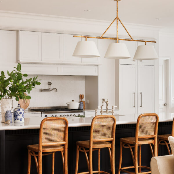 Modern French Provincial kitchen with island and rattan bar stools.