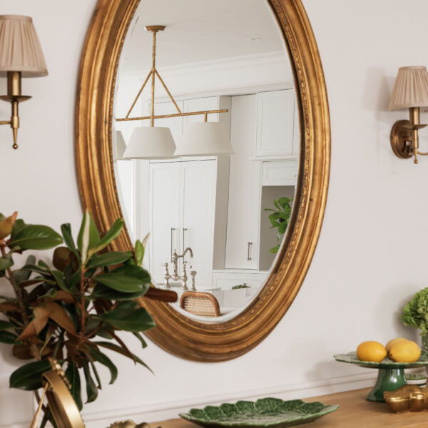 Elegant interior design with ornate mirror and stylish decor.