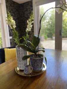 Elegant table setting with floral displays in the Beaumaris Project Gallery.