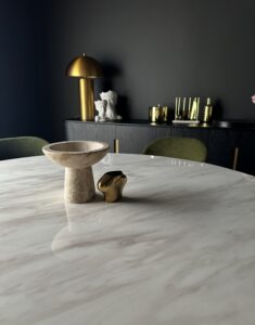 Elegant interior design with marble table and gold accents.