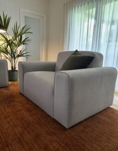 Comfortable grey armchair in Keilor Project Gallery setting