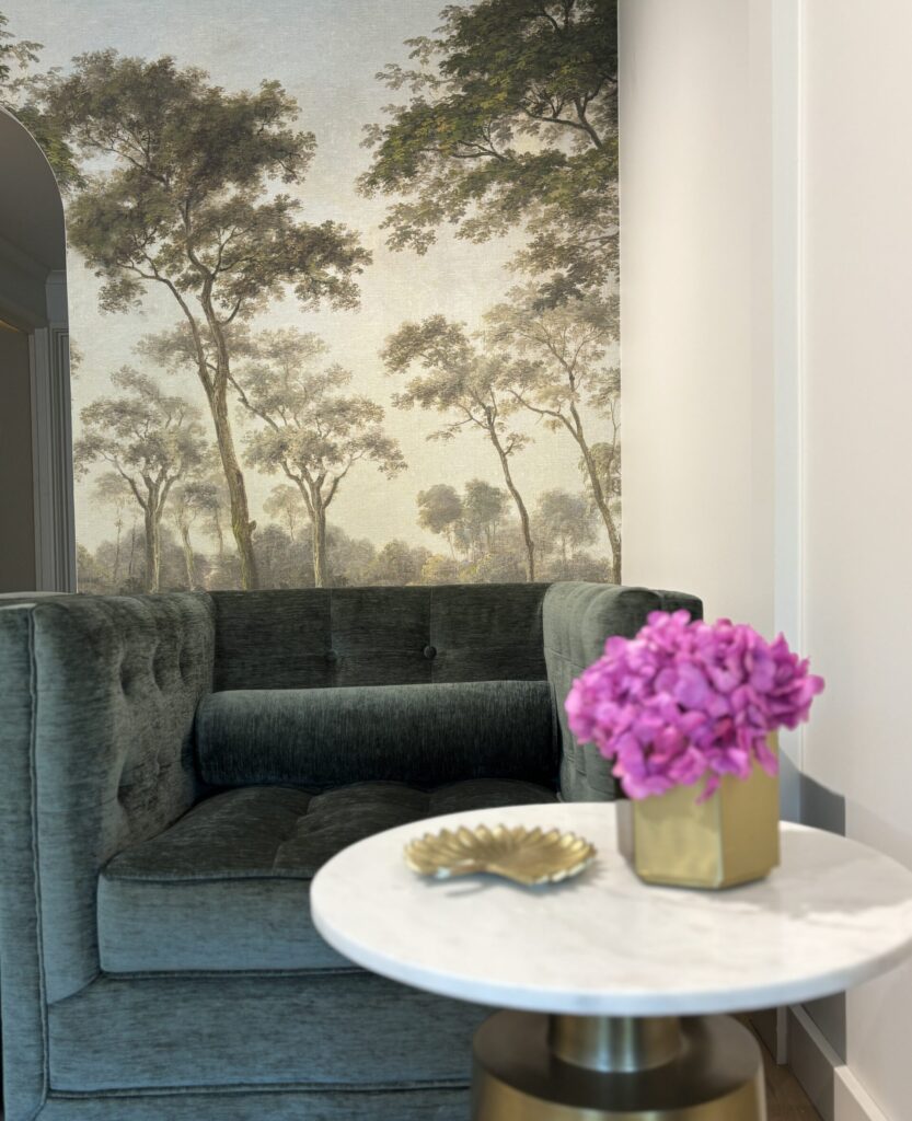 Elegant living area showcasing interior design with a forest-themed mural and chic furniture in Melbourne.