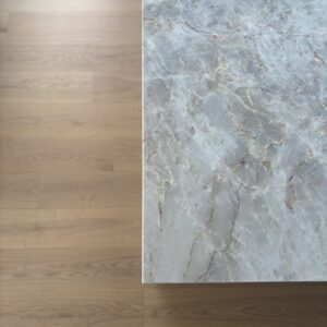 Marble countertop next to wooden floor in luxury Essendon West home
