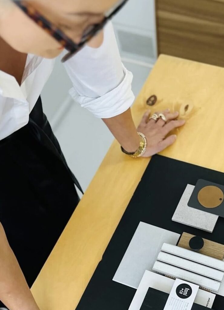 Designer examining materials on a table.