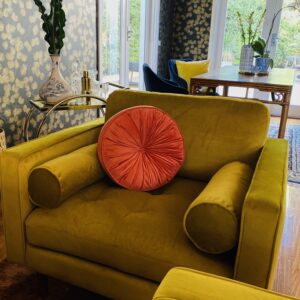 Stylish living room with a mustard armchair and pink cushion in Beaumaris Project Gallery.