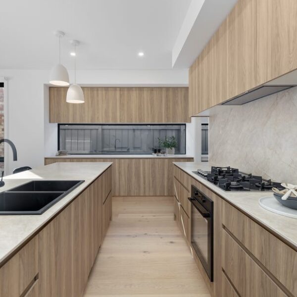 Modern kitchen design showcasing wooden cabinetry and sleek surfaces.