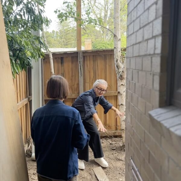 Two people discussing an outdoor design project in a Melbourne garden