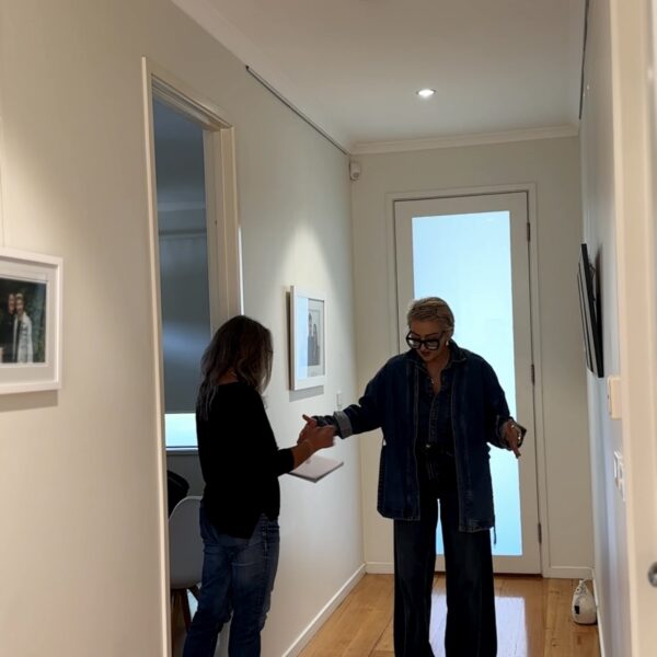 Two people discussing design ideas in a modern hallway