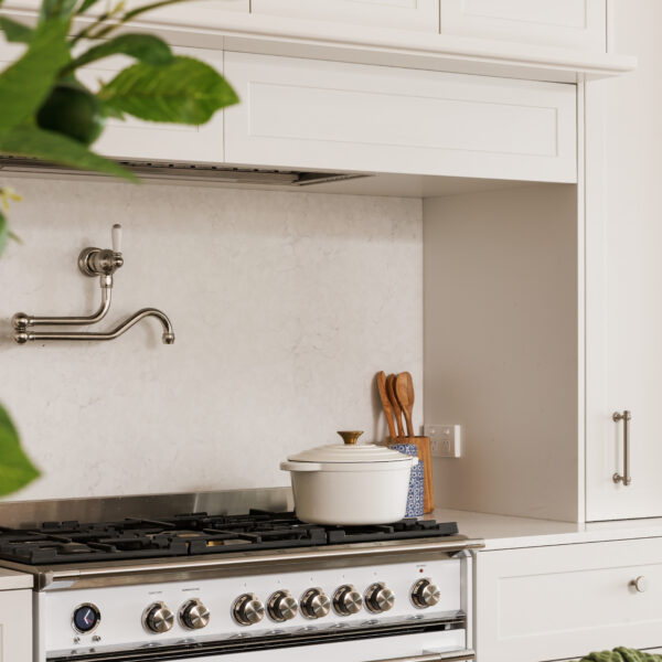 Modern French Provincial kitchen with white cabinetry and stove