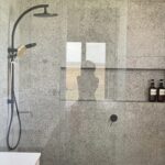 Modern bathroom with stone tiles and glass shower in Peterborough Project gallery
