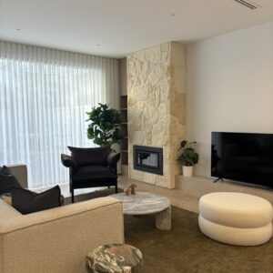 Modern living room in Beachside Townhouse with stone fireplace