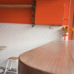 Bright orange and white interior decor in Gelato Lab Gallery
